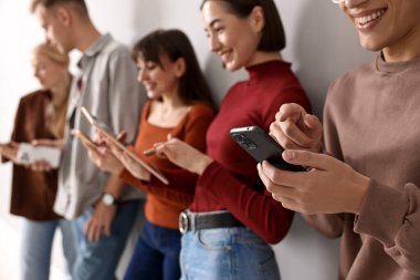 İçerideki ışık duvarının yanında farklı aletler kullanan bir grup insan. Modern teknoloji