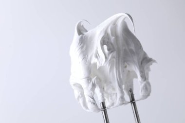 Beyaz arka planda çırpılmış kremalı çırpma çırpma, yakın plan. Metin için boşluk