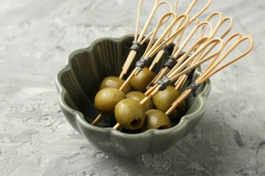 Gri dokulu masada salamura edilmiş zeytinler, yakın plan.