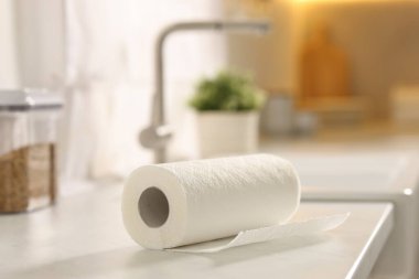 Roll of paper towels on white countertop in kitchen