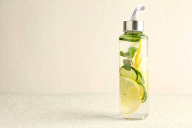 Nane aromalı limon suyu ve bej masadaki salatalık dilimleri, mesaj için yer.