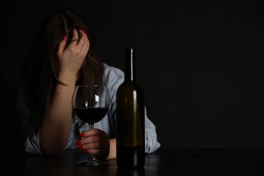 Alkol bağımlılığı. Masasında şarap olan sefil bir kadın. Metin için boşluk