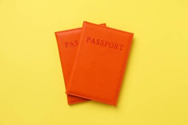 Sarı arka planda parlak kapaklı pasaportlar, üst manzara
