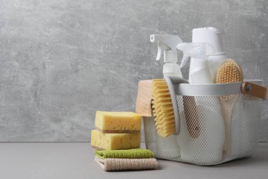 Gri masa üzerinde çevre dostu temizlik ürünleri ve malzemeler, metin için alan