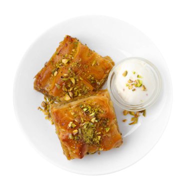 Lezzetli baklava, doğranmış fındıklı ve beyaza izole edilmiş dondurma kepçesi.