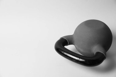Gri arka planda metal bir kettlebell, mesaj için yer var. Spor malzemeleri.