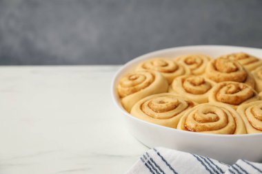 Çiğ tarçın kabın içinde, beyaz mermer masanın üzerinde, yakın plan. Metin için boşluk