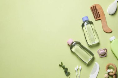 Bebek yağı ve banyo aksesuarları arka planda, düz yerde. Metin için boşluk