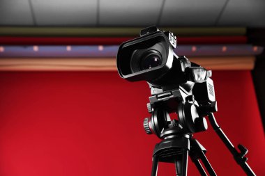 Moda stüdyosunda tripodu olan modern video kamera, metin için yer