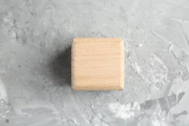 Gri desenli masa üzerinde boş bir tahta küp, üst manzara.