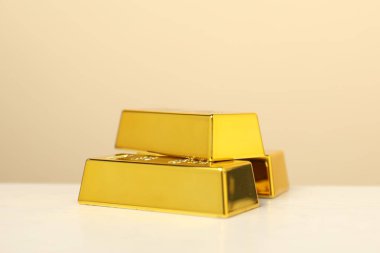 Bej arka planda parlak altın çubuklar, yakın plan