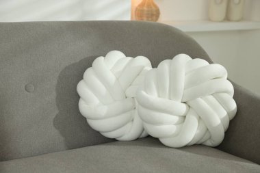 Odadaki kanepede yumuşak dekoratif yastıklar.