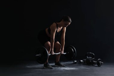 Siyah arka planda halterli kadın eğitimi