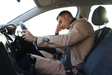 Modern arabasında uyuyan yorgun sürücü.