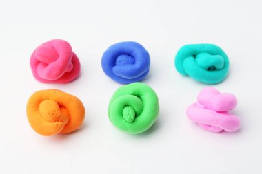 Beyaz arkaplanda farklı renkte oyun hamuru, yakın plan