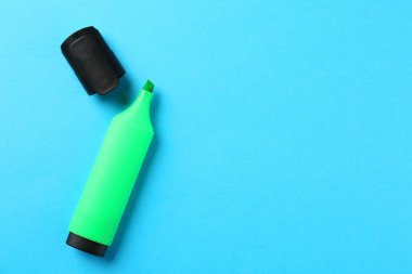 Açık mavi arka planda parlak fosforlu kalem ve kapak, düz yatıyordu. Metin için boşluk