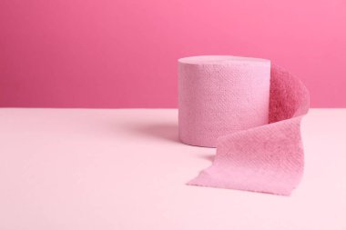 Pembe arka planda renkli tuvalet kağıdı rulosu. Metin için boşluk