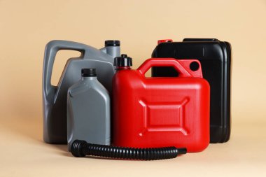 Many different plastic canisters on beige background