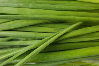 Fresh green onions as background, top view