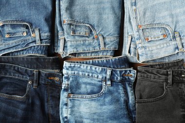 Stylish jeans on light brown background, flat lay