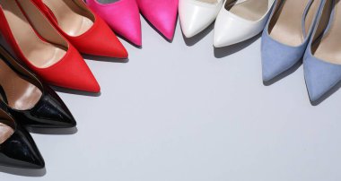 High heeled shoes on light background, above view. Space for text