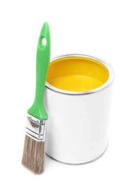 Can of yellow paint and brush isolated on white