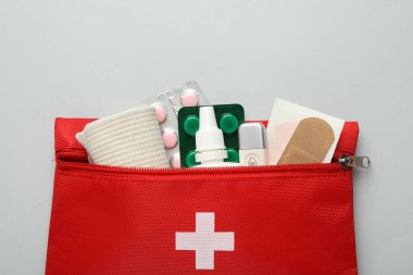 First aid kit on gray background, top view