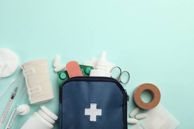 First aid kit. Different medical supplies on light blue background, flat lay. Space for text