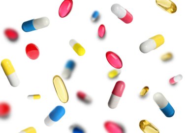 Many different pills flying on white background