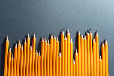 Many graphite pencils on grey background, flat lay