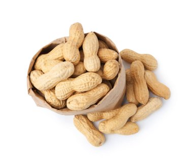 Unpeeled peanuts and paper bag isolated on white, top view