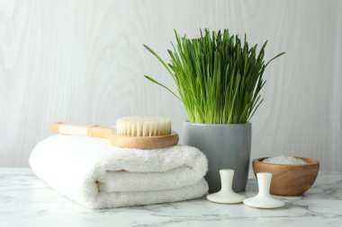 Spa composition with wheatgrass on white marble table