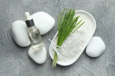 Spa composition with wheatgrass on grey background, flat lay