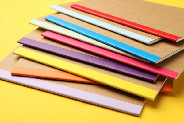 Many different copybooks on yellow background, closeup