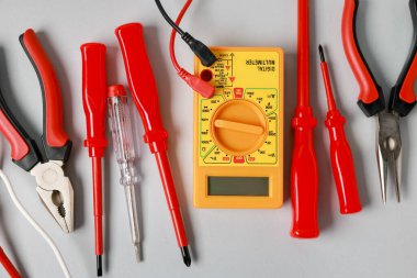 Different electrical tools on grey background, flat lay
