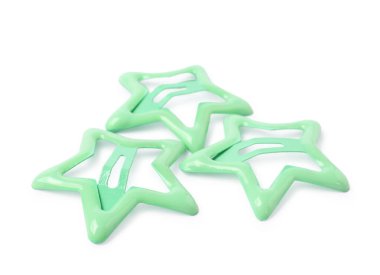 Many green star shaped hair clips isolated on white
