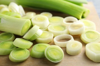 Fresh chopped leeks on wooden table, closeup
