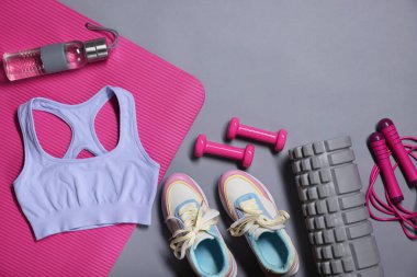 Different gym stuff on grey background, flat lay. Space for text