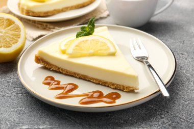 Gri desenli masada servis edilen lezzetli limonlu cheesecake.