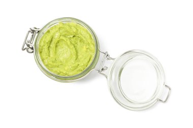 Tasty avocado dip in glass jar isolated on white, top view