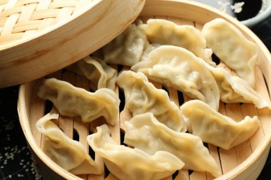 Bambu buharlı tencerede kaynamış gyoza (hamur tatlısı), yakın plan.