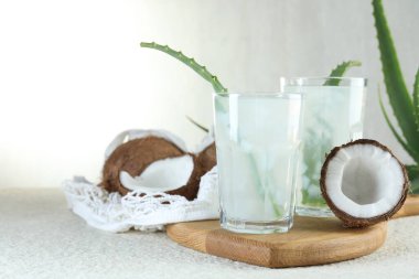 Beyaz desenli masa üzerinde hindistan cevizi ve aloe ile taze içecek.