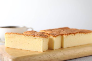 Tasty Japanese Castella sponge cake served on light table, closeup. Space for text