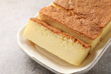 Tasty Japanese Castella sponge cake on light table, closeup