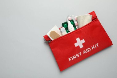 First aid kit on gray background, top view