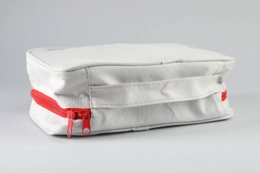 First aid kit on light grey background, closeup