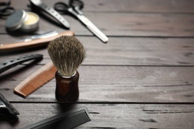 Many different barber's tools on wooden table, closeup. Space for text