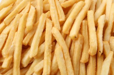 Pile of delicious French fries as background, closeup