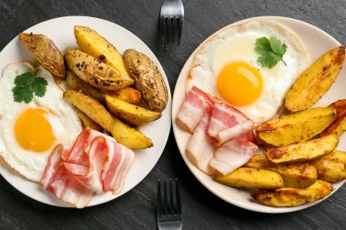 Flat lay composition with tasty brunch served on dark textured table