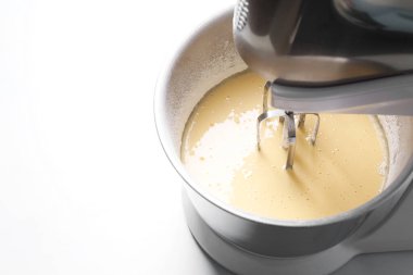 Making dough in bowl of stand mixer at white table, above view. Space for text